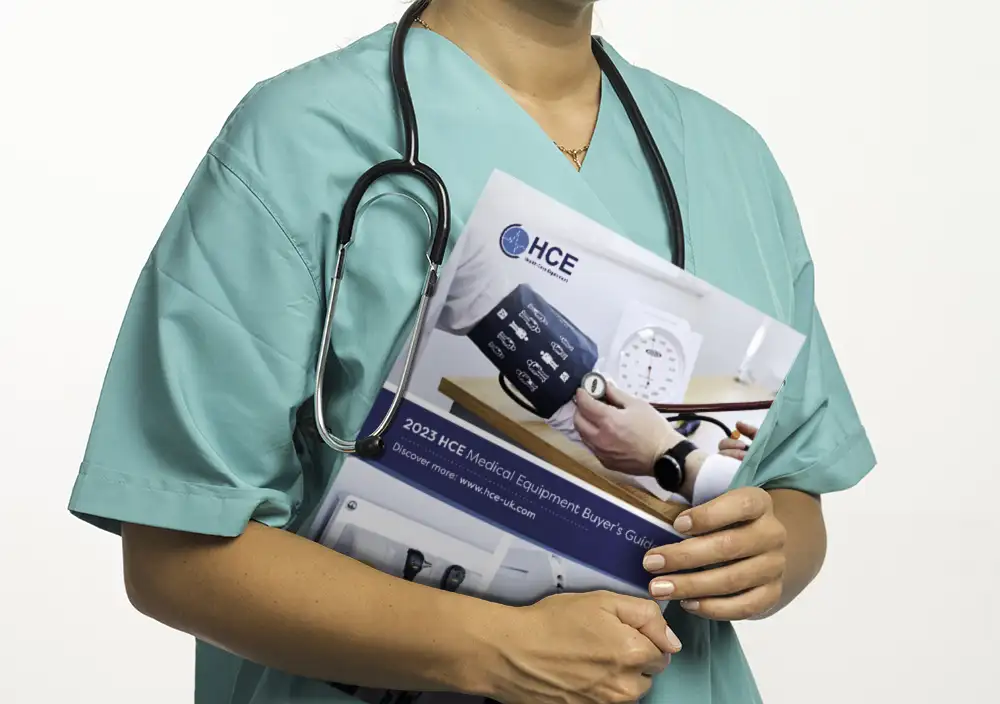Female nurse holding 2023 HCE Catalogue