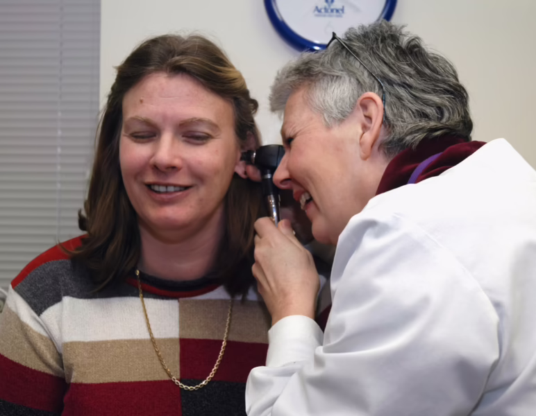 A doctor using an otoscope during an exam